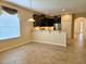 Open-concept kitchen with granite countertops, stainless steel appliances and dark wood cabinets at 3506 Creswick Cir, Orlando, FL 32829
