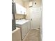 Well-lit laundry room with tile floor, cabinets, and white washer and dryer at 3506 Creswick Cir, Orlando, FL 32829