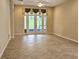 Bright living room featuring tile flooring, ceiling fan, and sliding glass doors leading to outdoor space at 3506 Creswick Cir, Orlando, FL 32829