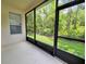 View from the screened in lanai of the lush trees and landscaping in the backyard at 3506 Creswick Cir, Orlando, FL 32829
