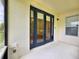 Covered patio with dark-framed sliding glass doors providing access to the home's interior at 3506 Creswick Cir, Orlando, FL 32829