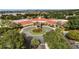 An aerial view showcasing the clubhouse entrance and a beautifully landscaped roundabout at 3586 Eversholt St, Clermont, FL 34711