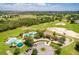 Aerial view of a community pool, golf course and lush landscaping surrounding the property in a picturesque setting at 3586 Eversholt St, Clermont, FL 34711