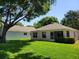 A spacious backyard with lush green grass and mature landscaping providing privacy and tranquility at 3586 Eversholt St, Clermont, FL 34711