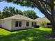 The manicured backyard features a well-maintained lawn and mature trees at 3586 Eversholt St, Clermont, FL 34711