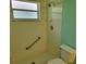 Bathroom area featuring shower and toilet with bars at 3586 Eversholt St, Clermont, FL 34711