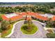 Aerial view of the clubhouse with beautiful landscaping and a circular driveway at 3586 Eversholt St, Clermont, FL 34711