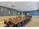 This spacious conference room features a large table, comfortable seating, and a wall-mounted TV for presentations at 3586 Eversholt St, Clermont, FL 34711