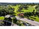 Aerial view of the entrance to Kings Ridge surrounded by a golf course and lush landscaping at 3586 Eversholt St, Clermont, FL 34711