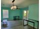 Open living room with unique light fixture and sliding glass doors to the outside at 3586 Eversholt St, Clermont, FL 34711