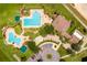 Aerial view of a sparkling community pool with lush landscaping creating a luxurious outdoor oasis at 3586 Eversholt St, Clermont, FL 34711