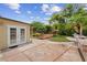 Expansive backyard with a stone patio, lush landscaping, and a charming pergola with a hammock at 408 S Winsome Ct, Lake Mary, FL 32746