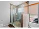 Bathroom with a walk-in shower featuring glass enclosure and a window for natural light at 408 S Winsome Ct, Lake Mary, FL 32746