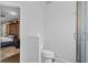 Clean, well-maintained toilet room, located adjacent to a bedroom and a modern shower with glass door at 408 S Winsome Ct, Lake Mary, FL 32746