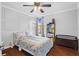 Comfortable bedroom with a ceiling fan, plush bed, natural light and a storage bench at 408 S Winsome Ct, Lake Mary, FL 32746