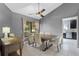Bright dining room featuring vaulted ceilings, a modern light fixture, and a large window at 408 S Winsome Ct, Lake Mary, FL 32746