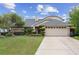 Charming single Gathering home with a well-manicured front yard and two car garage at 408 S Winsome Ct, Lake Mary, FL 32746
