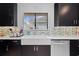 Modern kitchen with dark wood cabinets, stainless steel appliances and white countertops at 408 S Winsome Ct, Lake Mary, FL 32746