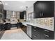 Contemporary kitchen with sleek cabinetry, stainless steel appliances, and tiled backsplash at 408 S Winsome Ct, Lake Mary, FL 32746