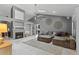Open-concept living room featuring a fireplace, tile floors, and a large comfortable sofa at 408 S Winsome Ct, Lake Mary, FL 32746
