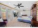 Spacious main bedroom with two ceiling fans, wood flooring, a wall-mounted TV, and large windows at 408 S Winsome Ct, Lake Mary, FL 32746