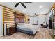 Spacious main bedroom featuring wood-look flooring, ceiling fans, and paneled accent wall at 408 S Winsome Ct, Lake Mary, FL 32746