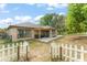 Exterior view of the back of the home with a fenced in backyard with patio and seating area at 43825 State Road 19, Altoona, FL 32702