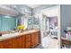 Bathroom with double sinks, nice counter tops, and view into bedroom at 43825 State Road 19, Altoona, FL 32702