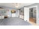 Comfortable bedroom with a ceiling fan, television, white furniture, and an attached bathroom at 43825 State Road 19, Altoona, FL 32702