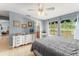 Serene bedroom with a view of the outdoors and a neutral color scheme, flowing to a Primary bathroom at 43825 State Road 19, Altoona, FL 32702