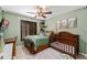 Cozy bedroom with a ceiling fan, a window with shutters, and decor including a crib and woodland-themed accents at 43825 State Road 19, Altoona, FL 32702