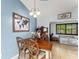 Bright dining room with a wooden table, stylish chairs, and a charming world map at 43825 State Road 19, Altoona, FL 32702