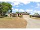 Charming single-story home featuring an attached garage and a well-manicured front yard at 43825 State Road 19, Altoona, FL 32702