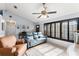 Cozy living room features tiled floors, window shutters, and comfortable seating at 43825 State Road 19, Altoona, FL 32702