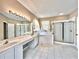 Bright bathroom boasts double vanity, soaking tub, and separate glass-enclosed shower at 508 Sycamore St, Celebration, FL 34747