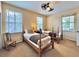 Bright bedroom showcasing two twin beds with ample natural light and a unique ceiling fan at 508 Sycamore St, Celebration, FL 34747