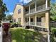 Elegant home featuring a charming front porch with white columns and well-maintained landscaping at 508 Sycamore St, Celebration, FL 34747