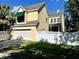 Inviting yellow home with a screened porch, fenced yard, and attached garage at 508 Sycamore St, Celebration, FL 34747