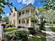 Elegant two-story home featuring multiple balconies, columns, a well-manicured lawn, and classic curb appeal at 508 Sycamore St, Celebration, FL 34747