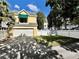Yellow home with attached garage, awning, and manicured lawn behind a white picket fence at 508 Sycamore St, Celebration, FL 34747