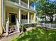Charming front porch with classic columns, a ceiling fan, manicured landscaping, and an inviting entrance at 508 Sycamore St, Celebration, FL 34747