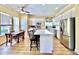 Bright kitchen with white cabinets, stainless steel appliances, an island, and wood floors at 508 Sycamore St, Celebration, FL 34747