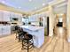 Modern kitchen with white cabinets, stainless steel appliances, an island, and wood floors at 508 Sycamore St, Celebration, FL 34747