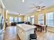 Bright, open-concept living space with an island, wood floors, and multiple windows for plenty of natural light at 508 Sycamore St, Celebration, FL 34747
