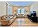Inviting living room with light wood floors, two sofas, and natural light streaming through the windows at 508 Sycamore St, Celebration, FL 34747