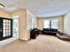 Bright living room featuring a black leather sofa, accent furniture, and an inviting entryway at 508 Sycamore St, Celebration, FL 34747