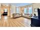 Cozy living room with wood floors, comfortable sofas, and a view into the adjacent bedroom at 508 Sycamore St, Celebration, FL 34747