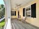 Charming porch with rocking chairs and classic architectural details and black shutters at 508 Sycamore St, Celebration, FL 34747