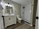 Newly remodeled bathroom boasts a modern vanity, sleek white subway tile shower, and stylish fixtures at 5216 Davisson Ave, Orlando, FL 32810