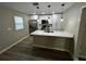 Modern kitchen features white cabinets, quartz countertops and stainless steel appliances at 5216 Davisson Ave, Orlando, FL 32810